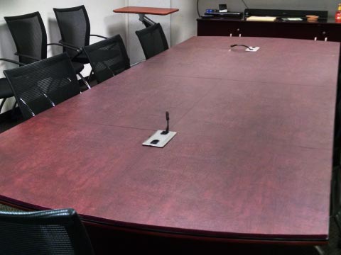 Conference room table pad with cutouts for microphones
