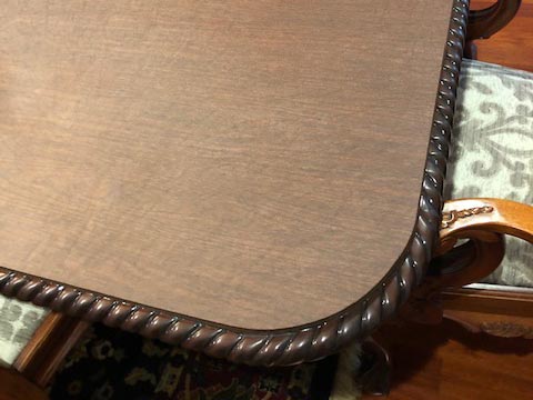 Close-up of rounded corner on protector for table with carved edge